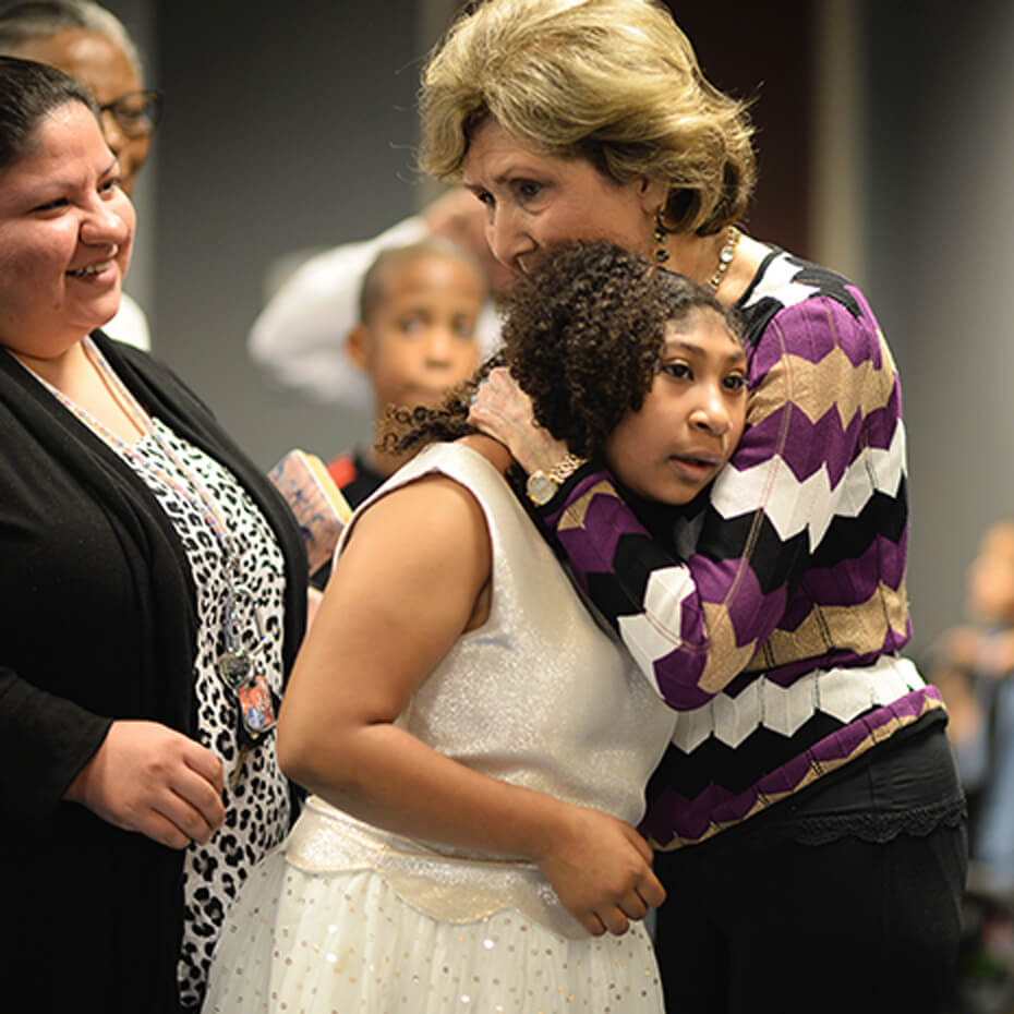 Ms. Dodie prays over a Champions Club child at Lakewood Church